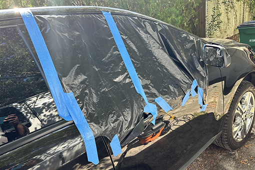 Car Window Covered by Plastic in Sarasota County FL Before Owner Gets Auto Glass Repair Services