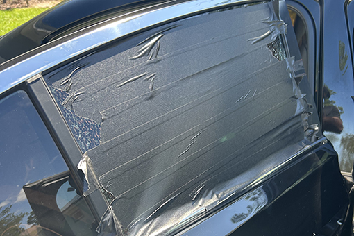 Broken Car Window Temporarily Covered With Tape While Riverview Owner Is Deciding Where to Have It Repaired