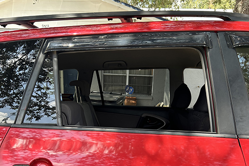 Car in Need of Window Replacement Parked at a House in Riverview Florida