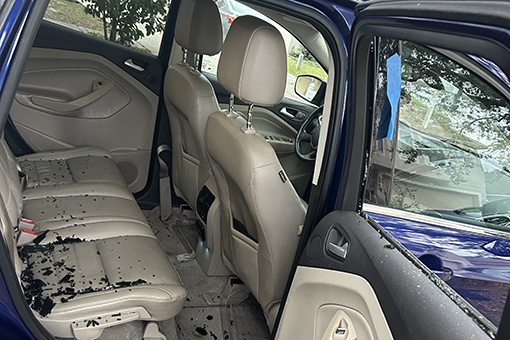 Blue Car With Broken Window In Need of Car Window Replacement Near Riverview FL